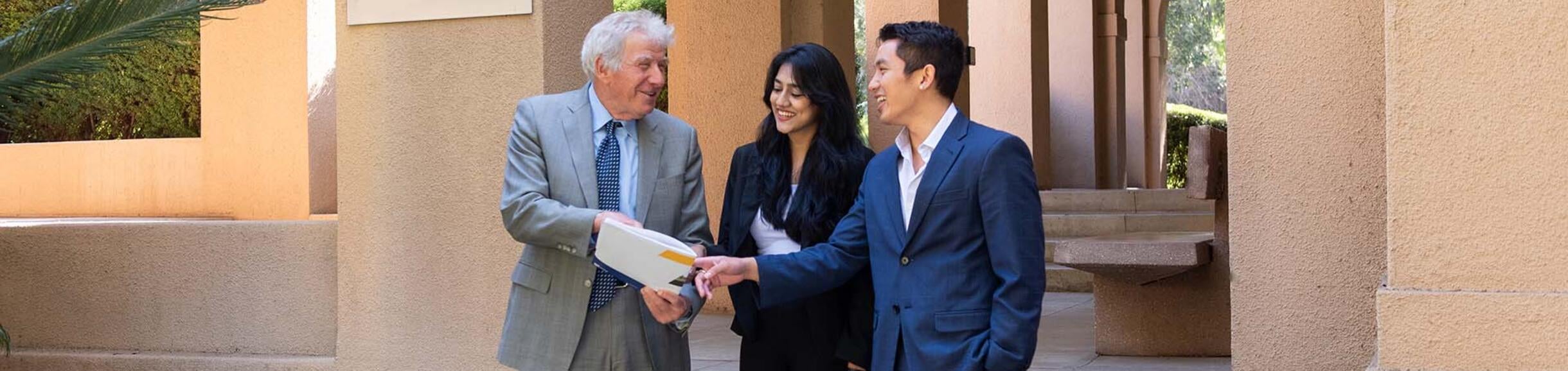 UCR School of Business professor and 2 students